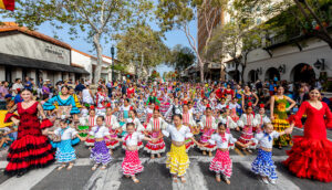 Colorful Santa Barbara Fiesta Childrens' Parade participants moving down State Street