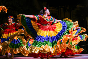 Santa Barbara Fiesta dancers in colorful dresses during Noches de Ronda